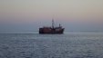 Cargo Ship Leaving At Sunset